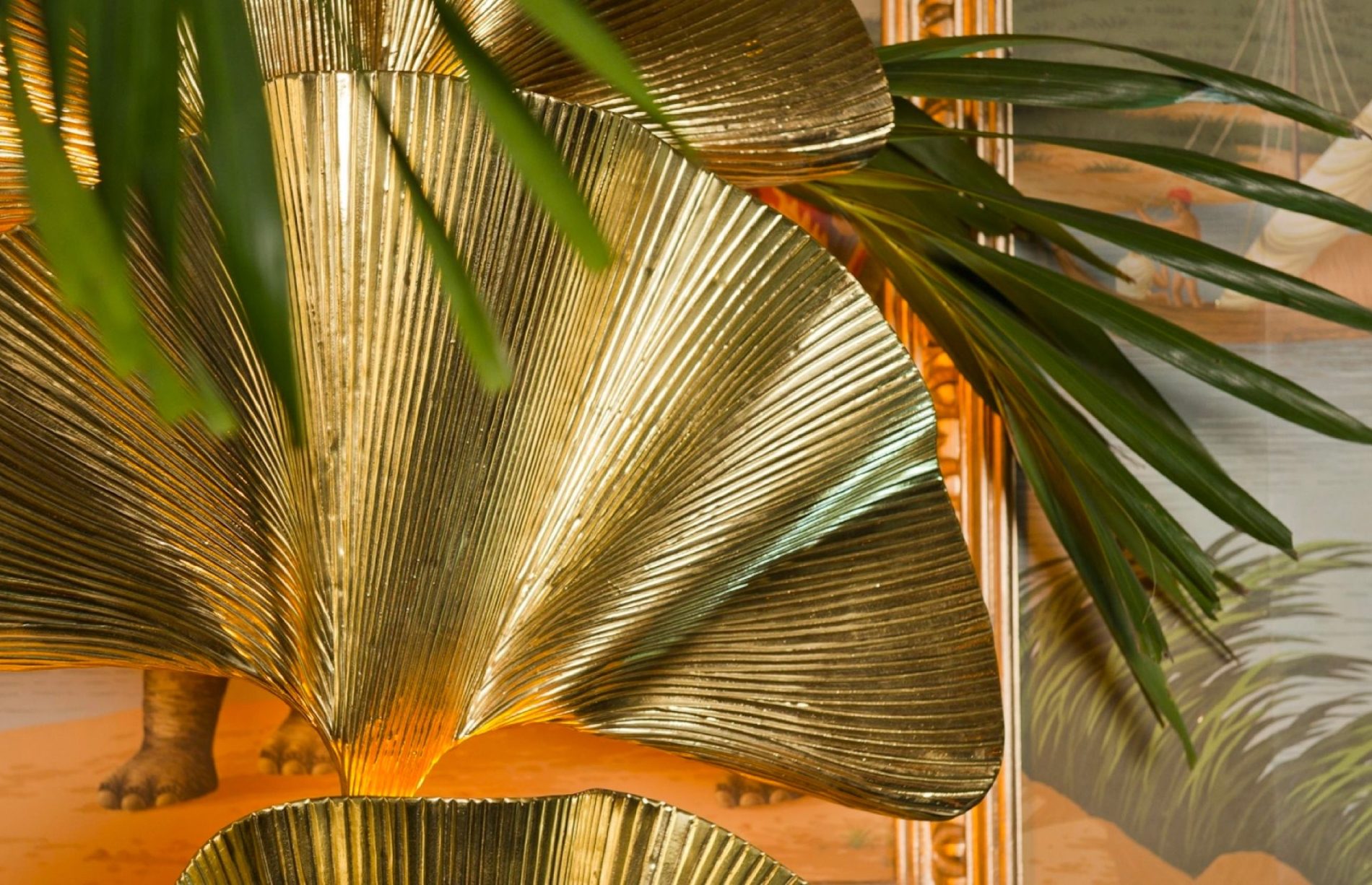 Gold palm-leaf sculpture among tropical plants