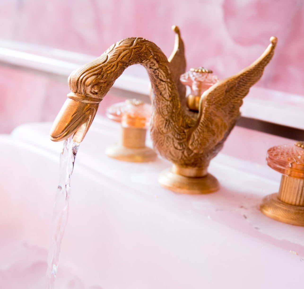 Gold swan tap in the famous pink bathroom