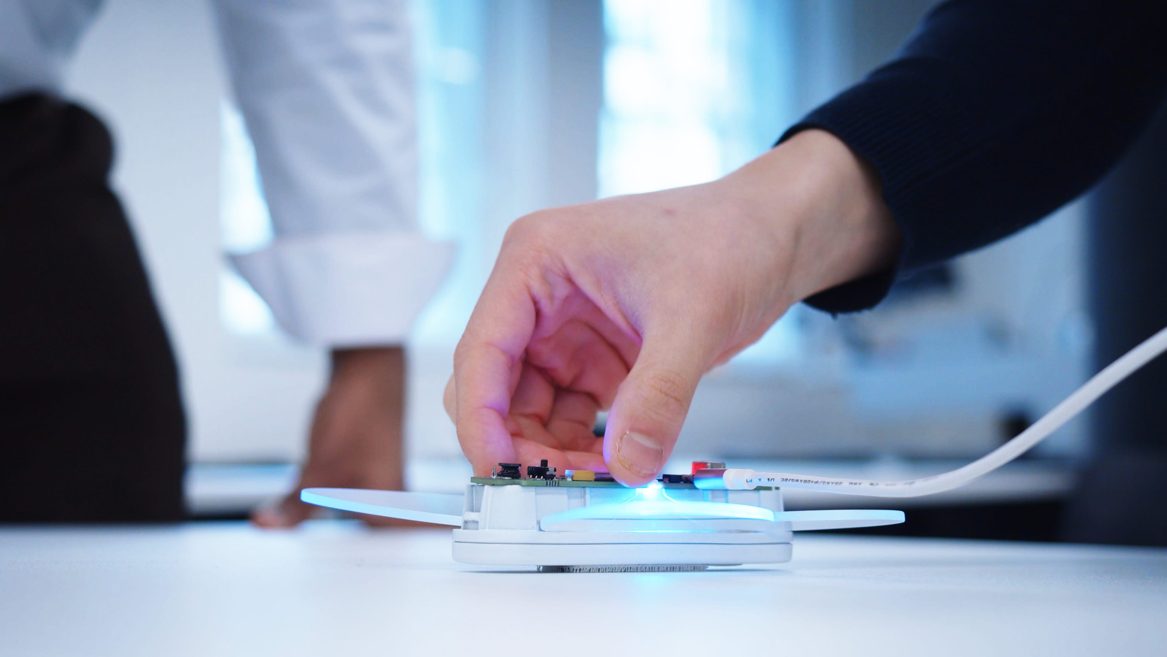 Hand placing a device on a test rig