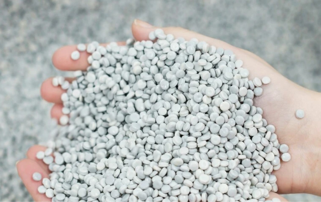 Hands holding recycled plastic pellets